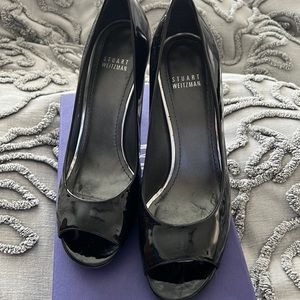 Stuart Weitzman “stylish” black patent peep toe pump